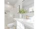 Modern bathroom featuring a glass shower, white vanity, and elegant gold fixtures at 8142 Cliffside Dr, Charlotte, NC 28270