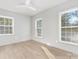 Light-filled room with three large windows and hardwood floors at 8142 Cliffside Dr, Charlotte, NC 28270