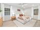 Bedroom with neutral tones, ceiling fan, and two windows providing ample natural light at 8142 Cliffside Dr, Charlotte, NC 28270