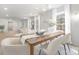 Bright dining room featuring wood table, white chairs, and modern chandelier at 8142 Cliffside Dr, Charlotte, NC 28270