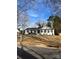 Charming single-story home featuring white painted brick, black shutters, and a well-manicured lawn at 8142 Cliffside Dr, Charlotte, NC 28270