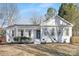 Charming home featuring a crisp white exterior with dark shutters and a well-manicured front yard at 8142 Cliffside Dr, Charlotte, NC 28270