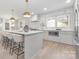 Modern kitchen featuring white cabinets, stainless steel appliances, and a marble backsplash at 8142 Cliffside Dr, Charlotte, NC 28270