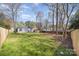 Expansive backyard surrounded by mature trees and a wooden fence, offering privacy at 9105 Touchstone Ln, Charlotte, NC 28227