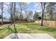 Well-maintained backyard with lush green grass and a concrete patio, ideal for outdoor activities at 9105 Touchstone Ln, Charlotte, NC 28227