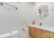 Modern bathroom with a stylish wood vanity, sink, and hexagon mirror at 9105 Touchstone Ln, Charlotte, NC 28227