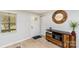 Bright entryway featuring wood floors, a decorative mirror, and ample natural light at 9105 Touchstone Ln, Charlotte, NC 28227