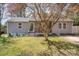 Charming home with a well-manicured lawn, mature landscaping, and inviting front porch at 9105 Touchstone Ln, Charlotte, NC 28227