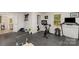 Home gym features a treadmill, exercise bike, weight rack, and mirrored wall at 9105 Touchstone Ln, Charlotte, NC 28227