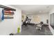 Well-equipped home gym with treadmill, exercise bike, weights, and rubber flooring at 9105 Touchstone Ln, Charlotte, NC 28227