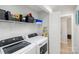 Well-organized laundry room featuring a modern washer and dryer with ample storage at 9105 Touchstone Ln, Charlotte, NC 28227