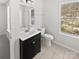 Bright bathroom with vanity, toilet, and window for natural light and ventilation at 9832 Veronica Dr, Charlotte, NC 28215