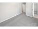 Bedroom with gray carpet and white walls with access to bathroom and closet at 9832 Veronica Dr, Charlotte, NC 28215