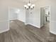 Open-concept dining room showcases modern wood flooring and leads seamlessly to other living spaces at 9832 Veronica Dr, Charlotte, NC 28215