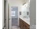 Bathroom featuring double sink vanity and open view to bedroom area at 10005 Chimney Dr, Waxhaw, NC 28173