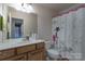 Bathroom featuring a sink with cabinet, a toilet, and a decorative shower curtain at 10005 Chimney Dr, Waxhaw, NC 28173