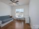 Bright bedroom with hardwood floors, ceiling fan, and natural light from the window at 10005 Chimney Dr, Waxhaw, NC 28173