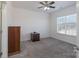 Bedroom with a wooden dresser, carpeting, and a large window at 10005 Chimney Dr, Waxhaw, NC 28173