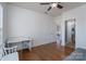 Bedroom features hardwood floors, desk, and an open doorway to the bathroom at 10005 Chimney Dr, Waxhaw, NC 28173