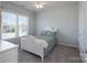 Bedroom with large window offering natural light, carpeting, and a white bed frame at 10005 Chimney Dr, Waxhaw, NC 28173