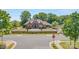 Wide angle of clubhouse with brick exterior, manicured lawn, and community pool at 10005 Chimney Dr, Waxhaw, NC 28173