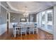 Dining room featuring hardwood floors, a coffered ceiling, stylish chandelier, and a large window at 10005 Chimney Dr, Waxhaw, NC 28173