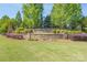 Grand stone entrance to The Chimneys of Marvin, surrounded by manicured landscaping and mature trees at 10005 Chimney Dr, Waxhaw, NC 28173