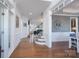 Elegant foyer with hardwood flooring, staircase, and decorative moldings, offering a glimpse into the home's layout at 10005 Chimney Dr, Waxhaw, NC 28173