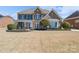 Beautiful two-story home featuring a brick and stone facade, manicured landscaping, and a welcoming covered front porch at 10005 Chimney Dr, Waxhaw, NC 28173