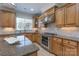 Beautiful kitchen with wooden cabinets, granite countertops, and stainless steel range at 10005 Chimney Dr, Waxhaw, NC 28173