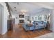 Spacious living room with hardwood floors, fireplace, built-in shelving, and a comfortable seating area at 10005 Chimney Dr, Waxhaw, NC 28173