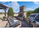 An outdoor stone fireplace with a built-in grill on a paver patio with partial shade at 10005 Chimney Dr, Waxhaw, NC 28173