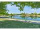 Scenic pond view with fountains, lush greenery, and community walking path, perfect for serene living at 10005 Chimney Dr, Waxhaw, NC 28173