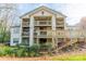 Multi-level home exterior featuring spacious decks and mature foliage at 1001 Churchill Downs Ct # A, Charlotte, NC 28211