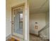 A front door with glass pane and a white trim and stairs nearby at 1001 Churchill Downs Ct # A, Charlotte, NC 28211
