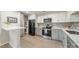 Modern kitchen features white and gray cabinets, stainless appliances, quartz countertops, and tiled backsplash at 1001 Churchill Downs Ct # A, Charlotte, NC 28211