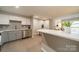 Updated kitchen featuring stainless steel appliances, two-tone cabinets, quartz counters, and modern backsplash at 1001 Churchill Downs Ct # A, Charlotte, NC 28211