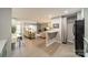 Open concept living area featuring hardwood floors, a view into the living room, and laundry closet at 1001 Churchill Downs Ct # A, Charlotte, NC 28211