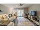 A living room with gray flooring and sliding glass doors to the balcony at 1001 Churchill Downs Ct # A, Charlotte, NC 28211