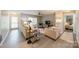 A living room with gray flooring and a sliding glass door that leads to the patio at 1001 Churchill Downs Ct # A, Charlotte, NC 28211