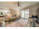 A living room with a ceiling fan and a sliding glass door to the patio at 1001 Churchill Downs Ct # A, Charlotte, NC 28211