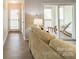 A living room with wood floors and a sliding glass door leading to the patio at 1001 Churchill Downs Ct # A, Charlotte, NC 28211