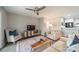 A living room with a ceiling fan and gray flooring and area rug at 1001 Churchill Downs Ct # A, Charlotte, NC 28211