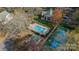 Aerial shot of the pool and tennis courts with the building in a park-like setting at 1001 Churchill Downs Ct # A, Charlotte, NC 28211