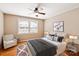 Cozy bedroom with a ceiling fan, comfortable armchair, and natural light from the windows at 103 S Laurel Ave, Charlotte, NC 28207