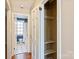 Hallway with shelf lined closet, leading to the full bath and other rooms at 103 S Laurel Ave, Charlotte, NC 28207