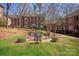 Exterior view of a brick building with a courtyard containing seating and greenery at 103 S Laurel Ave, Charlotte, NC 28207