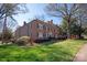 Three story brick building with manicured lawn and mature trees surrounding the property at 103 S Laurel Ave, Charlotte, NC 28207