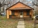 Charming one-story home featuring a covered front porch and quaint architectural details at 1128 Rosehill Dr, Lincolnton, NC 28092