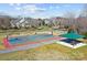 Outdoor basketball court with a covered picnic area and nearby residences at 11332 Westbranch Pkwy, Davidson, NC 28036